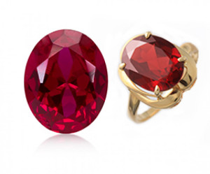 Oval red gemstone with gold ring setting and loose matching gem