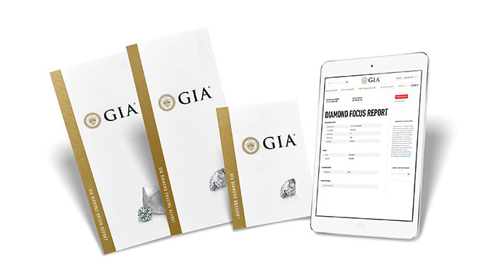 GIA diamond grading reports and a tablet showing a GIA Diamond Focus Report.