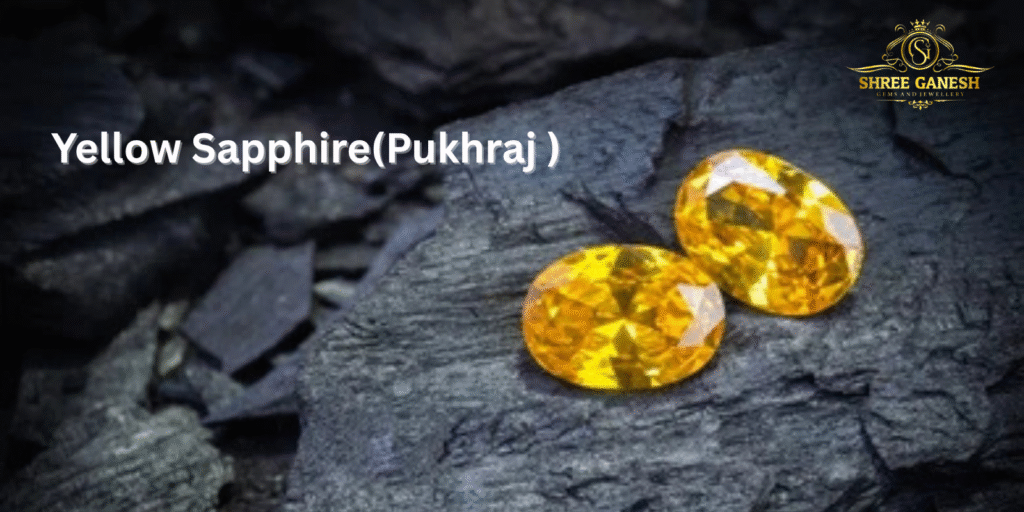 Two natural Yellow Sapphire Pukhraj gemstones placed on black slate, representing quality gems from Shree Ganesh Gems and Jewellery